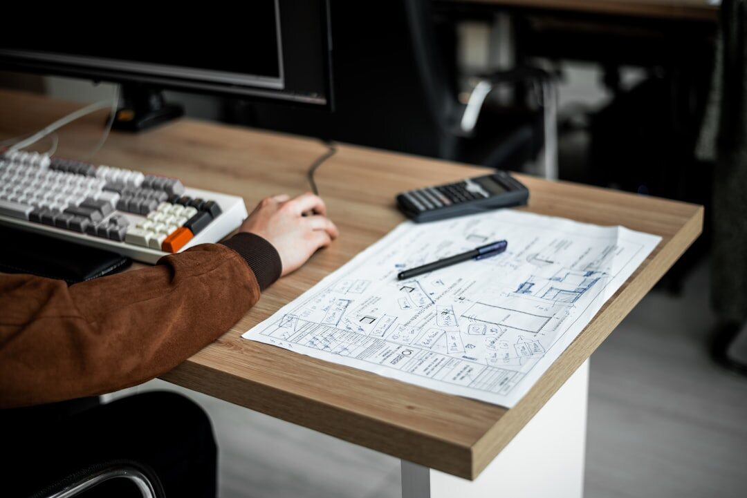 Architect working on digital blueprints on a large monitor