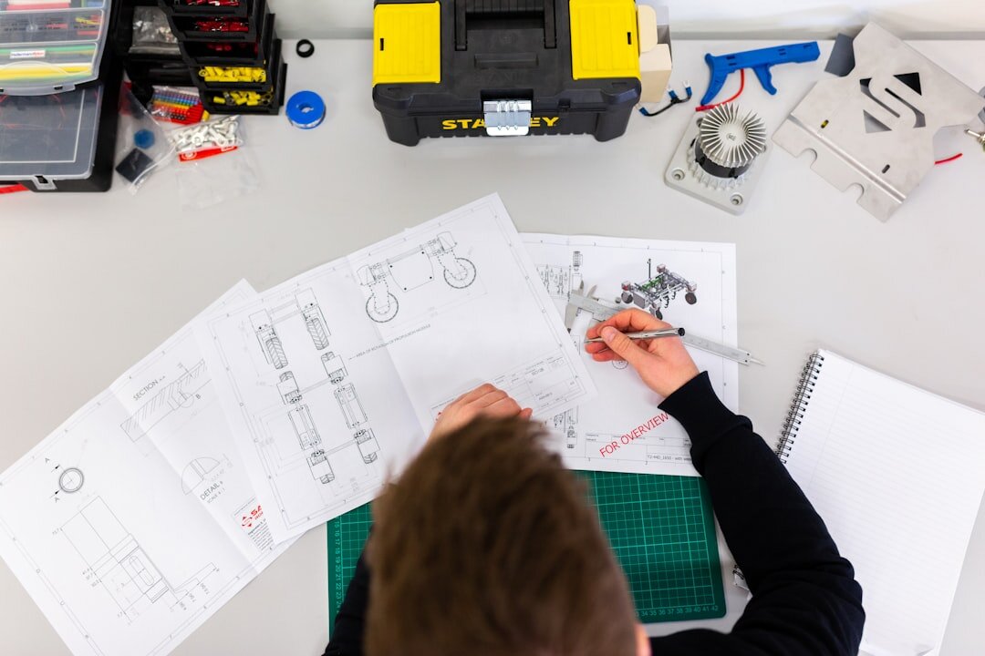 Engineer reviewing printed technical specification documents